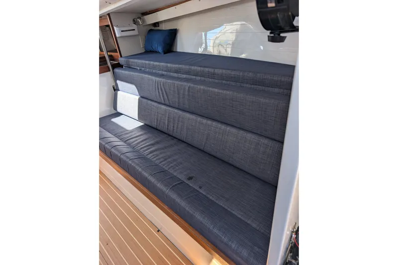 Slide: The Image of Interior seating of 2018 J Boats J/121, featuring blue cushions and wooden flooring. - 28