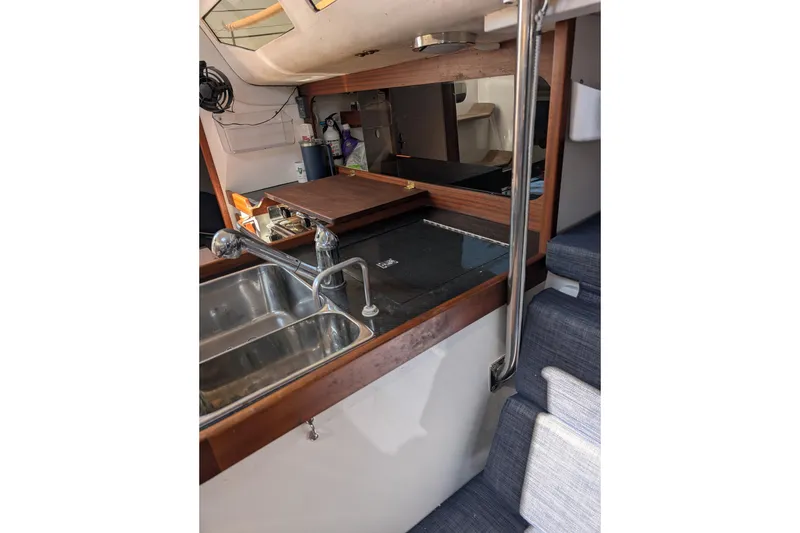 Slide: The Image of Interior of 2018 J Boats J/121 sailboat featuring a compact galley with sink and seating. - 37