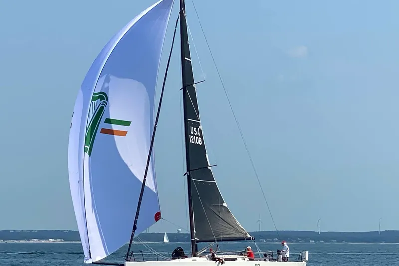 Slide: The Image of 2018 J Boats J/121 sailing with colorful spinnaker on open water. - 16