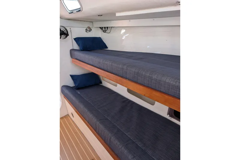 Slide: The Image of Interior of 2018 J Boats J/121 featuring cozy bunk beds with blue cushions. - 21