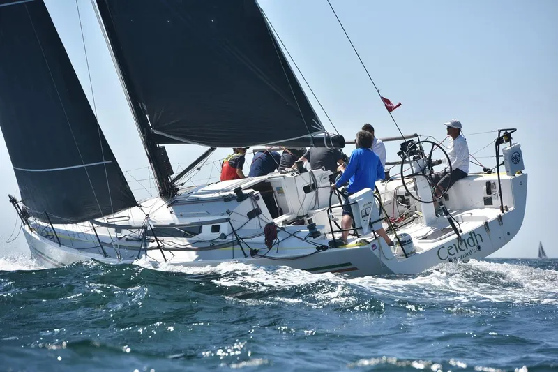 Slide: The Image of Sailing J Boats J/121, 2018 model, cutting through waves with crew onboard. - 5
