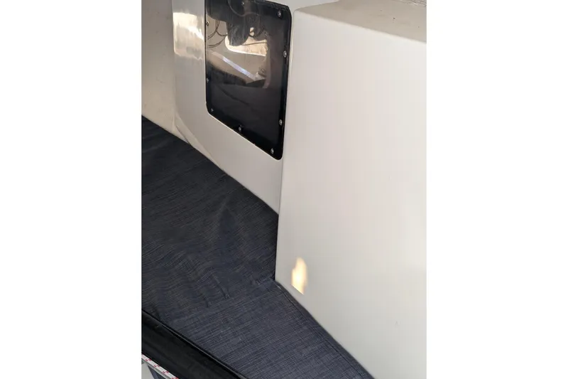 Slide: The Image of Interior view of 2018 J Boats J/121 sailboat cabin with window and seating area. - 32