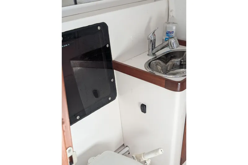 Slide: The Image of Interior of 2018 J Boats J/121 showing sink and faucet in compact bathroom. - 34