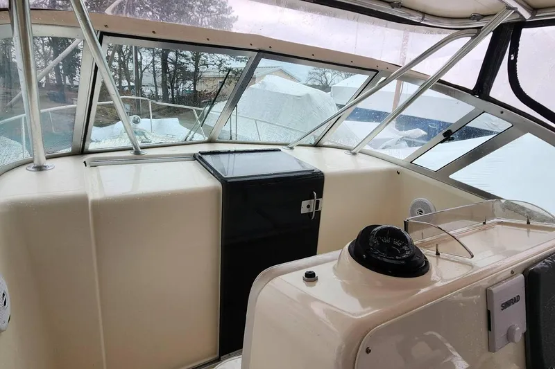 Slide: The Image of 2003 Pursuit 3070 Express boat interior with navigation equipment and windshield view. - 12