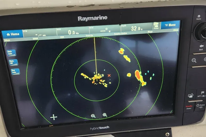 Slide: The Image of Raymarine radar display on 2003 Pursuit 3070 Express boat, showing navigation data. - 14