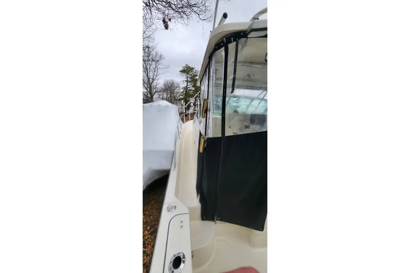 Slide: The Image of 2003 Pursuit 3070 Express boat with covered cockpit, docked outdoors. - 16