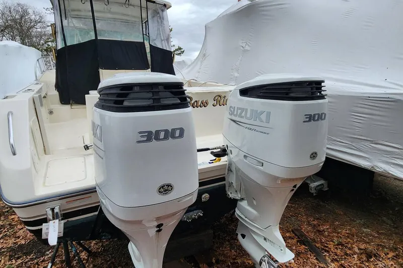 Slide: The Image of 2003 Pursuit 3070 Express boat with twin Suzuki 300 outboard engines. - 2