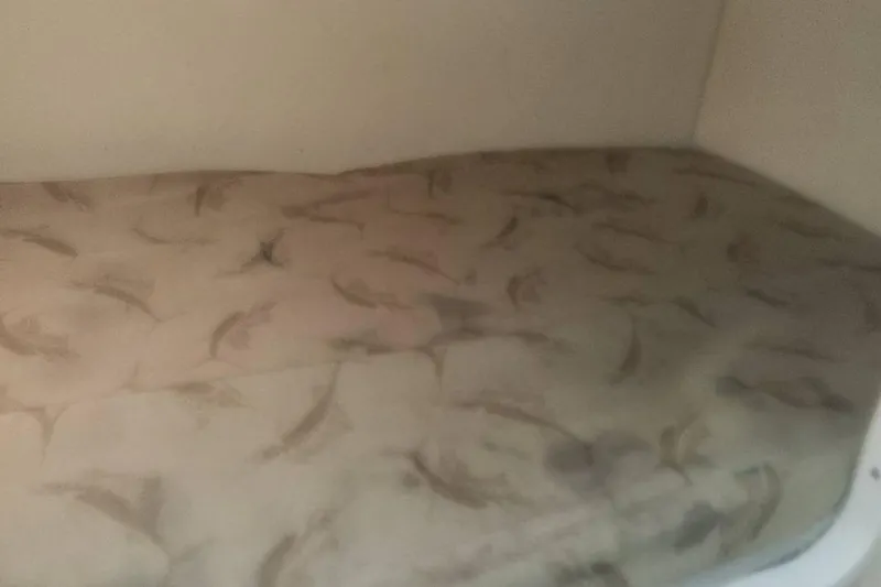 Slide: The Image of 2003 Pursuit 3070 Express cabin bed with patterned mattress. - 20