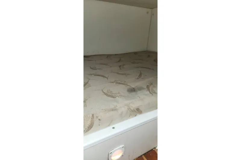 Slide: The Image of 2003 Pursuit 3070 Express cabin interior with patterned mattress. - 22