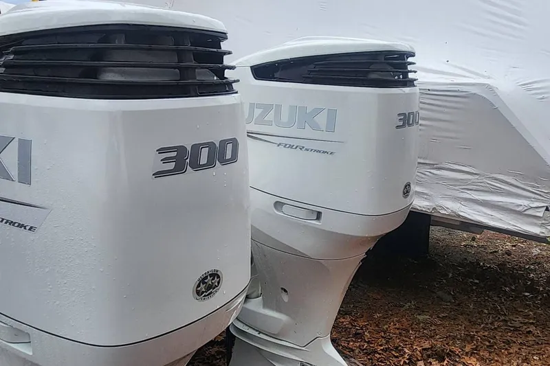 Slide: The Image of Twin Suzuki 300 outboard motors on a 2003 Pursuit 3070 Express boat. - 3