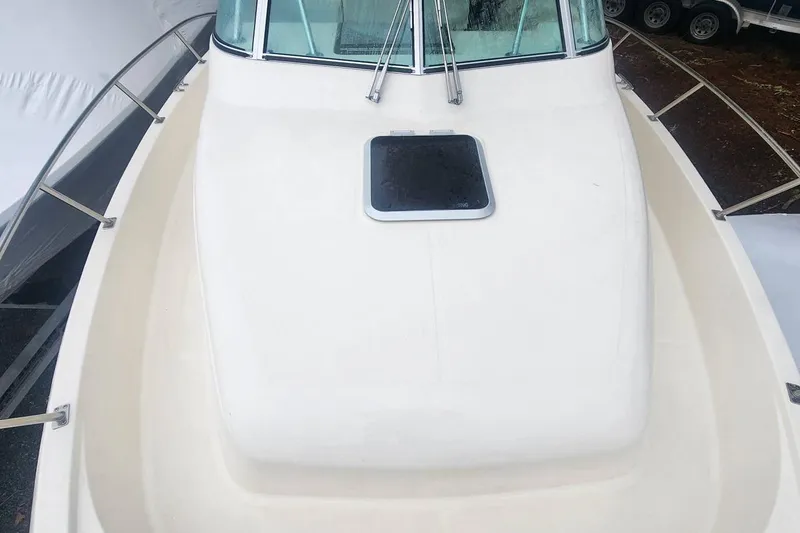 Slide: The Image of 2003 Pursuit 3070 Express boat deck with windshield and hatch. - 4