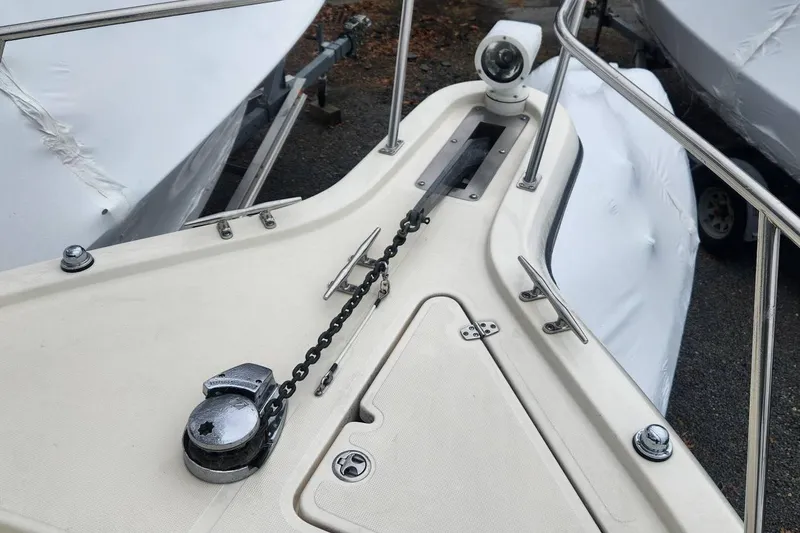 Slide: The Image of Bow of a 2003 Pursuit 3070 Express boat with anchor chain and winch. - 7