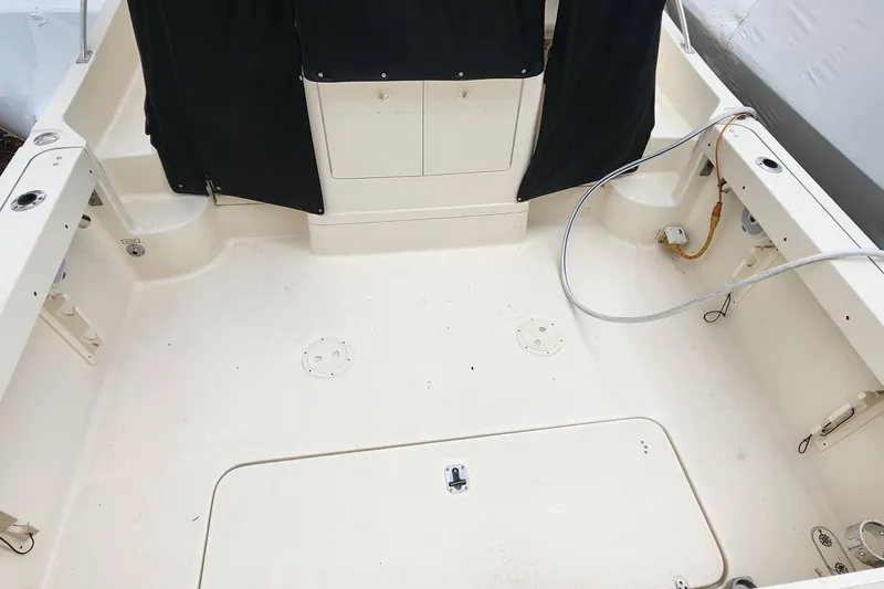 Slide: The Image of 2003 Pursuit 3070 Express boat deck with storage compartments and clean layout. - 8