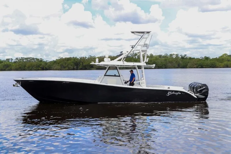 Slide: The Image of 2020 Yellowfin 39 Offshore boat on calm water with lush green background. - 10