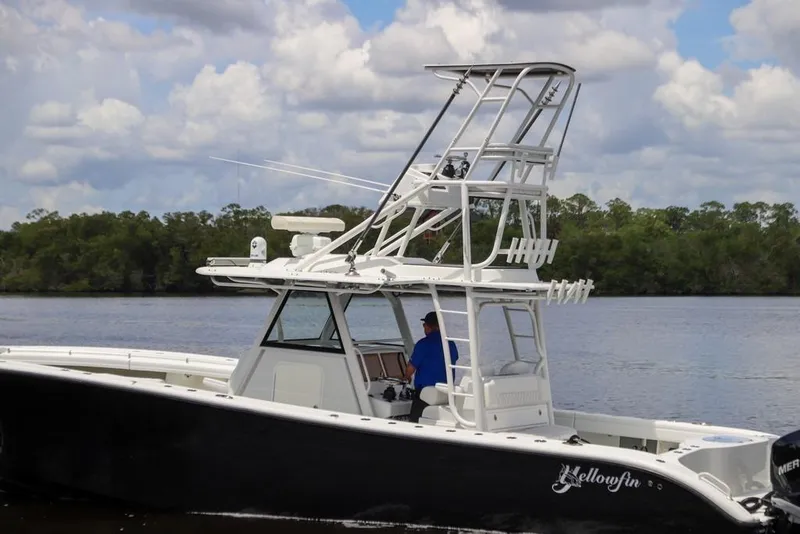 Slide: The Image of 2020 Yellowfin 39 Offshore boat on calm water with lush green background. - 11
