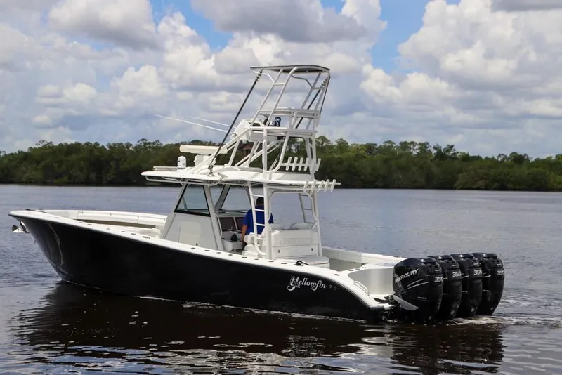 Slide: The Image of 2020 Yellowfin 39 Offshore boat with multiple outboard engines on a calm river. - 12