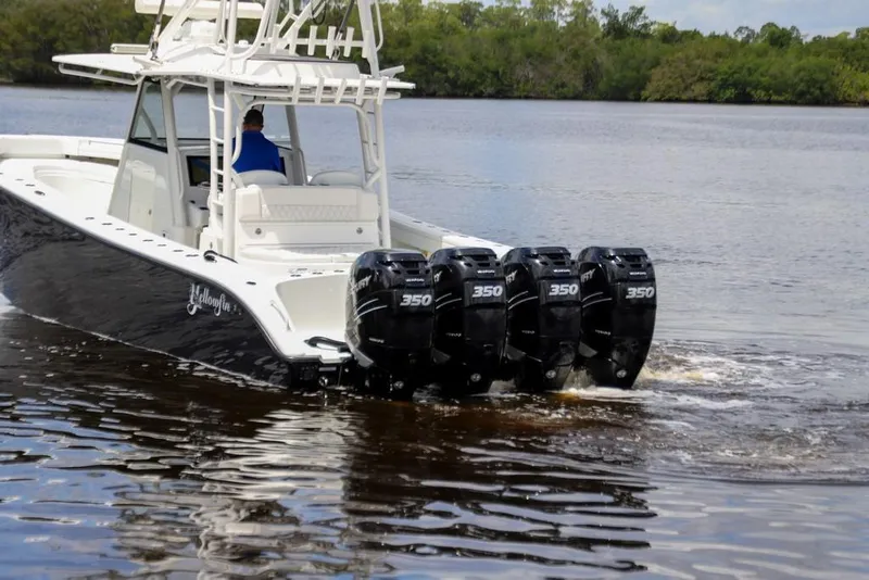 Slide: The Image of 2020 Yellowfin 39 Offshore boat with four powerful outboard engines on a calm river. - 14