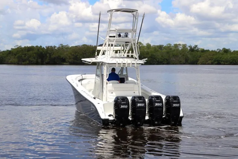 Slide: The Image of 2020 Yellowfin 39 Offshore boat with four powerful engines on a calm waterway. - 15