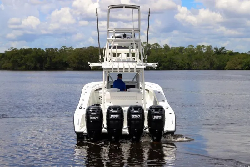 Slide: The Image of 2020 Yellowfin 39 Offshore boat with four powerful engines on a calm waterway. - 16