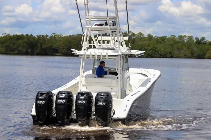 Slide: The Image of 2020 Yellowfin 39 Offshore boat with four powerful outboard engines on a calm waterway. - 17