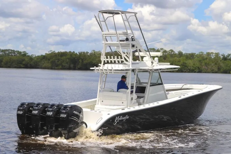 Slide: The Image of 2020 Yellowfin 39 Offshore boat with four Mercury engines on a calm river. - 18