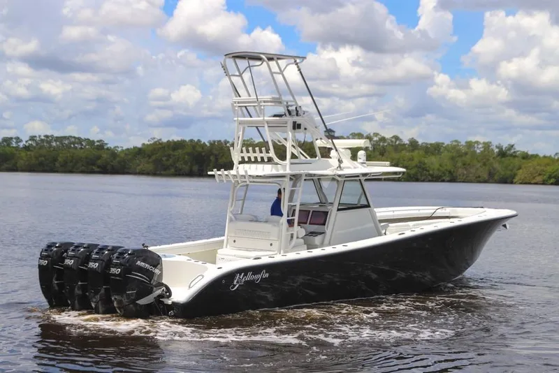Slide: The Image of 2020 Yellowfin 39 Offshore boat with multiple outboard engines on a calm river. - 19