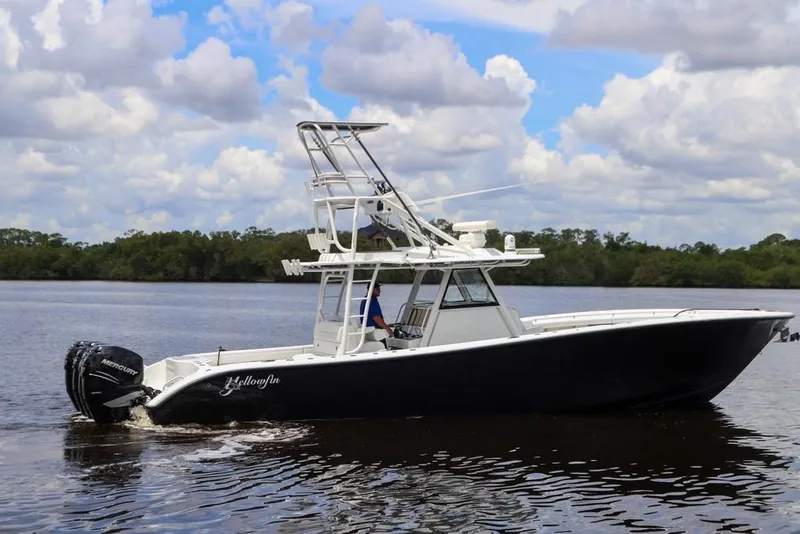 Slide: The Image of 2020 Yellowfin 39 Offshore boat cruising on a calm river under a cloudy sky. - 2