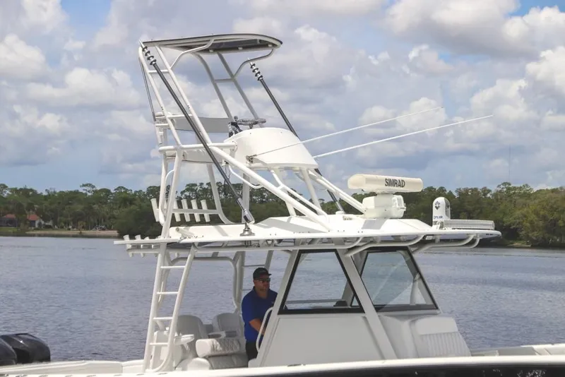 Slide: The Image of 2020 Yellowfin 39 Offshore boat with tower and radar on a calm lake. - 22