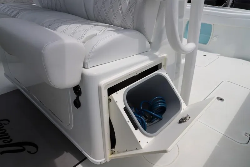Slide: The Image of 2020 Yellowfin 39 Offshore boat with open storage compartment and coiled hose. - 25