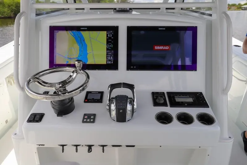 Slide: The Image of Control panel of 2020 Yellowfin 39 Offshore boat with navigation screens and steering wheel. - 29