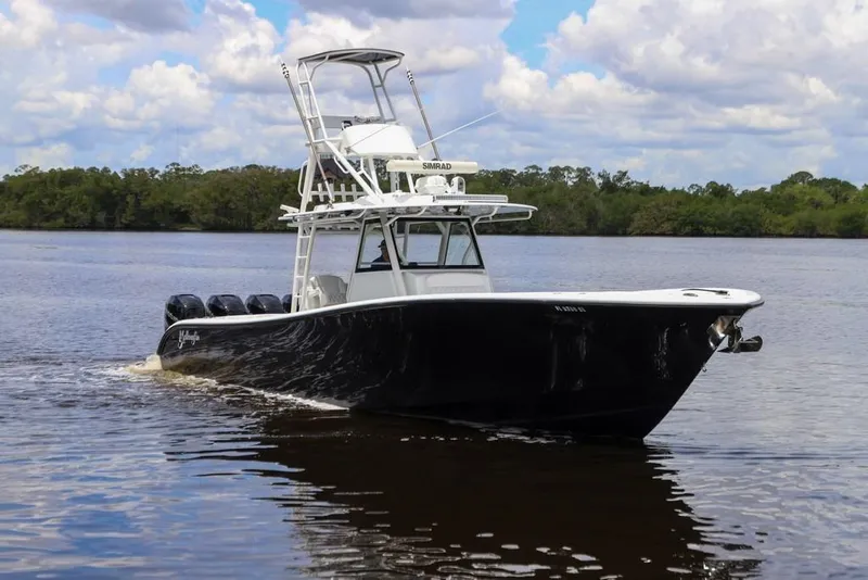 Slide: The Image of 2020 Yellowfin 39 Offshore boat cruising on a calm river under a cloudy sky. - 3