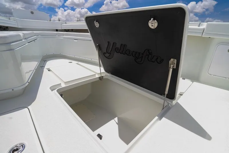 Slide: The Image of 2020 Yellowfin 39 Offshore boat storage compartment open under a blue sky. - 36