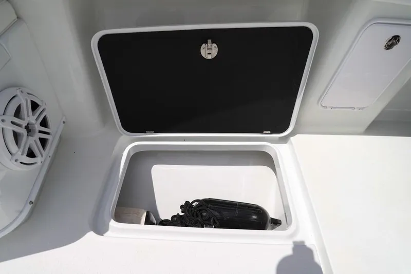 Slide: The Image of Open storage compartment on 2020 Yellowfin 39 Offshore boat, featuring a speaker and rope. - 38