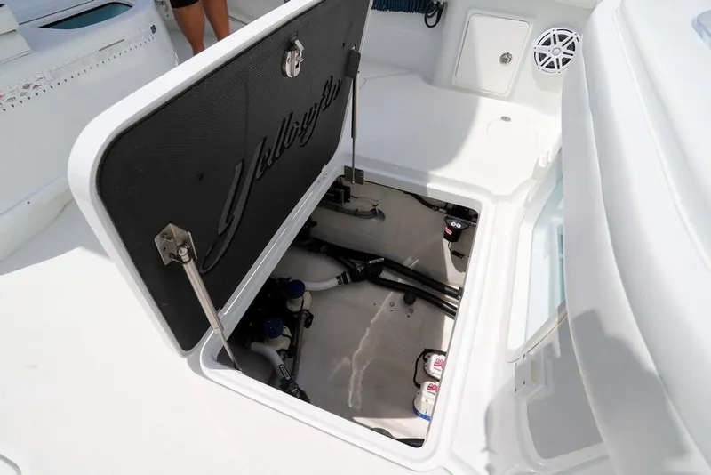 Slide: The Image of 2020 Yellowfin 39 Offshore boat storage compartment open, revealing interior components. - 47