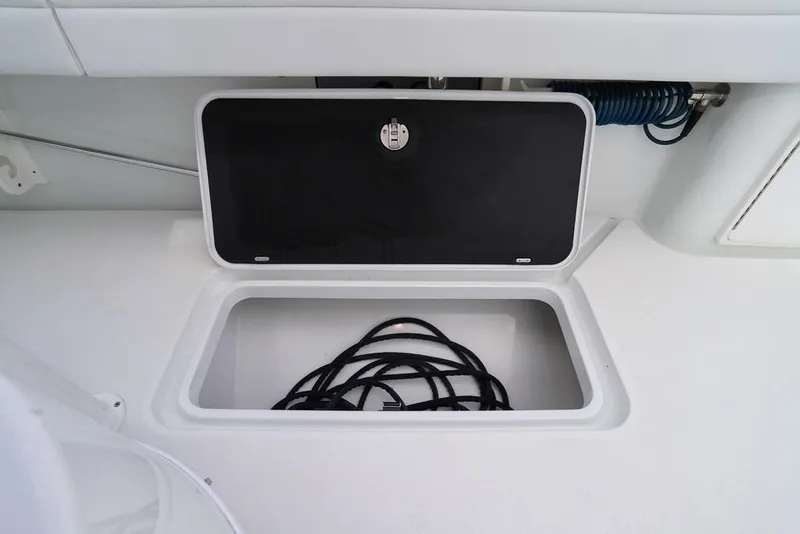Slide: The Image of Open storage compartment on 2020 Yellowfin 39 Offshore boat with coiled rope inside. - 49