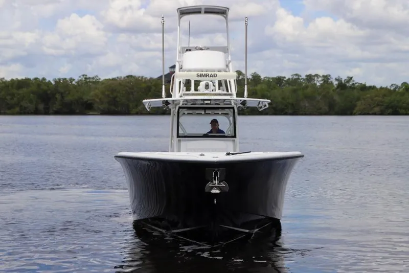 Slide: The Image of 2020 Yellowfin 39 Offshore boat on calm water, front view, under cloudy sky. - 5