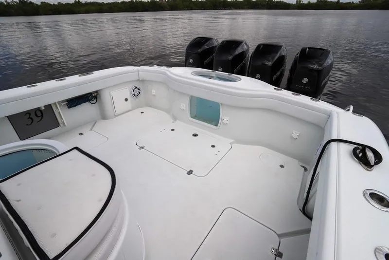 Slide: The Image of 2020 Yellowfin 39 Offshore boat deck with multiple outboard engines on calm water. - 55