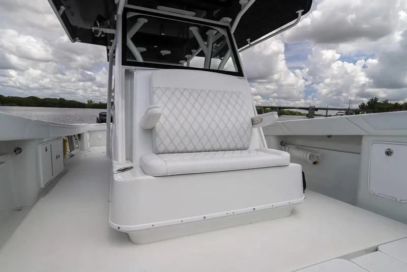 Slide: The Image of 2020 Yellowfin 39 Offshore boat interior with cushioned seating and open deck. - 60