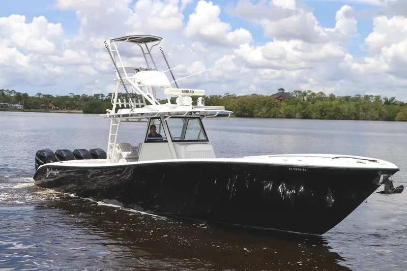 Slide: The Image of 2020 Yellowfin 39 Offshore boat cruising on a calm river under a cloudy sky. - 9