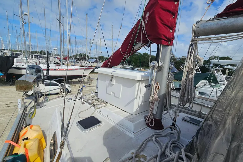 Slide: The Image of 1982 Morgan 462 sailboat deck with ropes and equipment in a marina setting. - 13