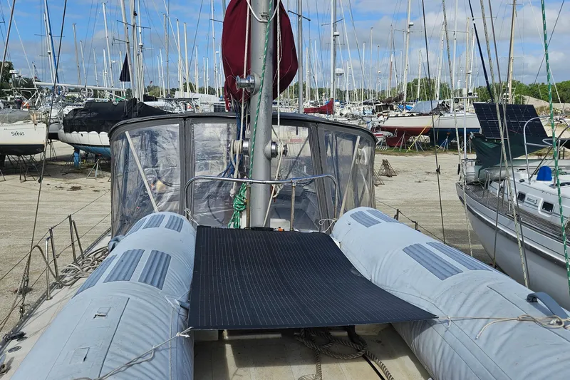 Slide: The Image of 1982 Morgan 462 sailboat docked, featuring solar panels and inflatable dinghy on deck. - 18