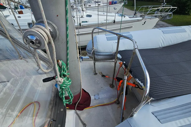 Slide: The Image of 1982 Morgan 462 sailboat deck with ropes and winch, docked alongside other boats. - 21