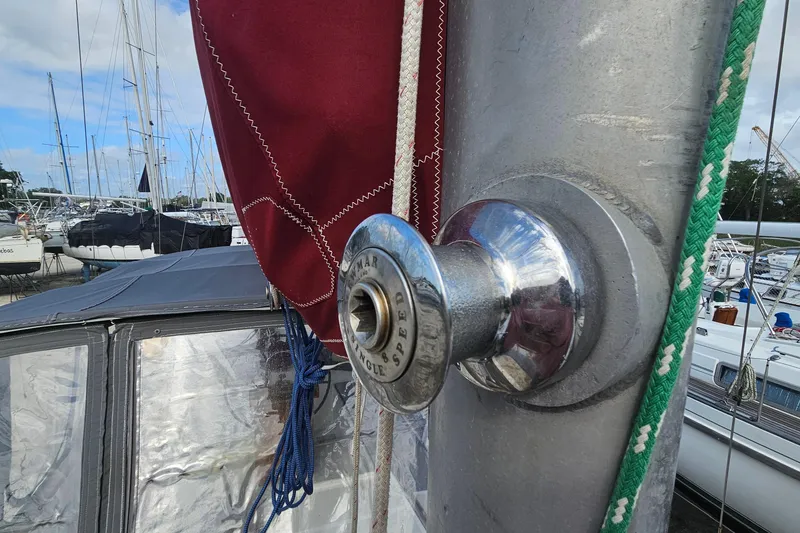 Slide: The Image of Close-up of a 1982 Morgan 462 sailboat winch with ropes and sails in a marina. - 22