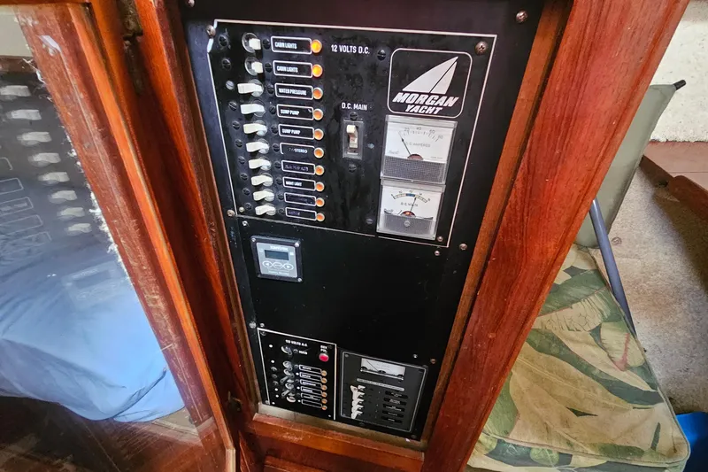 Slide: The Image of Interior of 1982 Morgan 462 sailboat with wood paneling and leaf-patterned upholstery. - 36