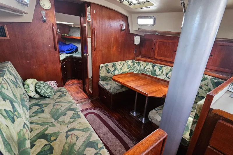 Slide: The Image of Cozy dining area in a 1982 Morgan 462 yacht with wooden table and leaf-patterned cushions. - 37