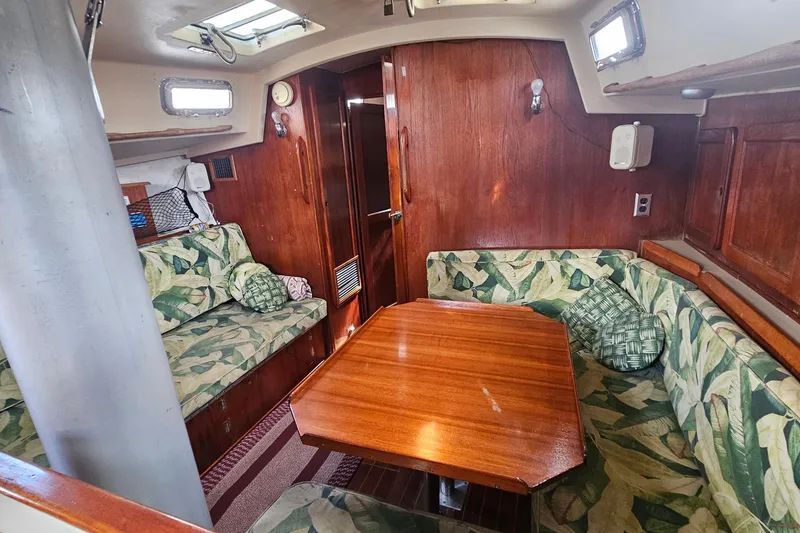 Slide: The Image of 1982 Morgan 462 yacht interior with tropical-patterned sofa and wooden finishes. - 39