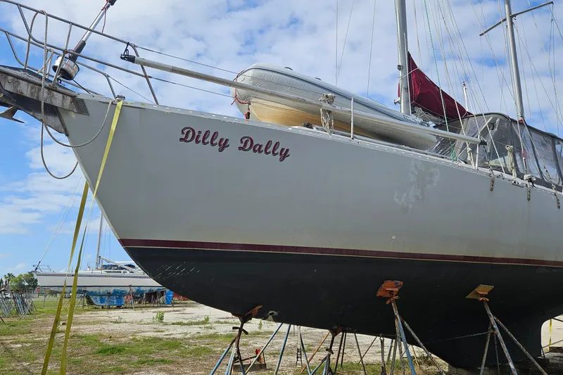Slide: The Image of 1982 Morgan 462 sailboat "Dilly Dally" on stands, with blue sky background. - 4