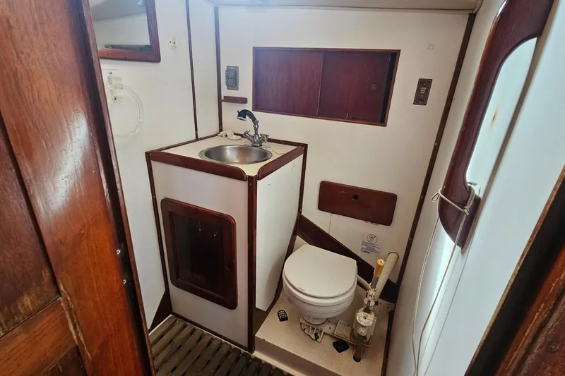 Slide: The Image of Cozy cabin interior of 1982 Morgan 462 sailboat with sleeping bag and wooden shelves. - 41