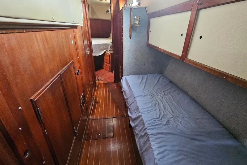 Slide: The Image of Engine room of a 1982 Morgan 462 sailboat, showcasing mechanical components and wiring. - 48