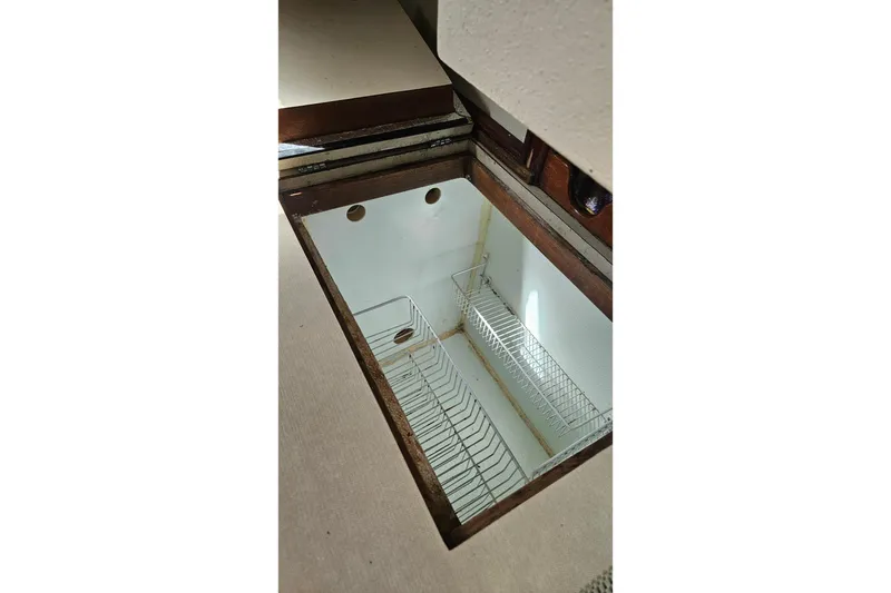 Slide: The Image of 1982 Morgan 462 boat with outboard motor and stainless steel grill on deck. - 63